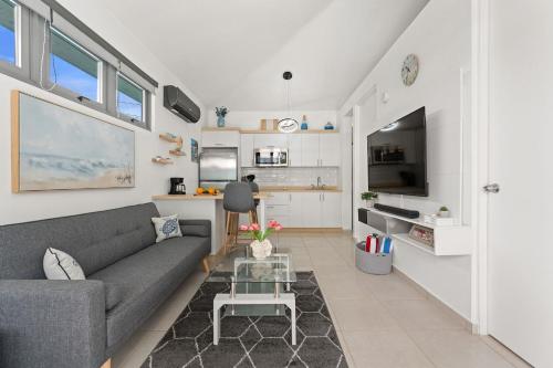 a living room with a couch and a table at Villas at Chalet De Buye in Cabo Rojo