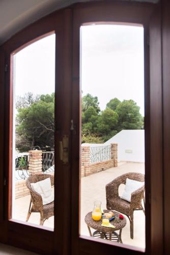 a view of a patio through a glass door at Affittacamere la Medusa in Porto Pino
