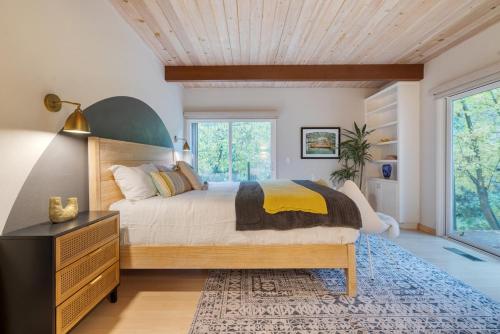 a bedroom with a large bed and a large window at Sonoma Creek Haven in Kenwood