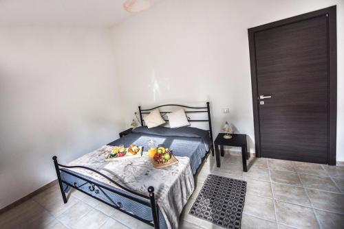a bedroom with a bed with fruit on it at Affittacamere la Medusa in Porto Pino