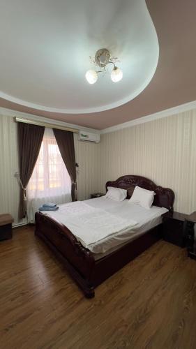 a bedroom with a bed with a ceiling at B&B Giza in Samarkand