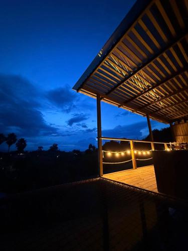 a lit up porch with lights at night at Alto Paraiso Glamping in Carmen de Viboral