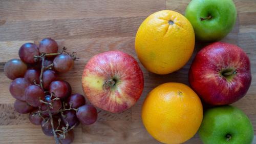 a group of fruits on a wooden table at Villas at Chalet De Buye in Cabo Rojo