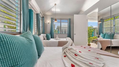 a hotel room with two beds and a balcony at Villas at Chalet De Buye in Cabo Rojo