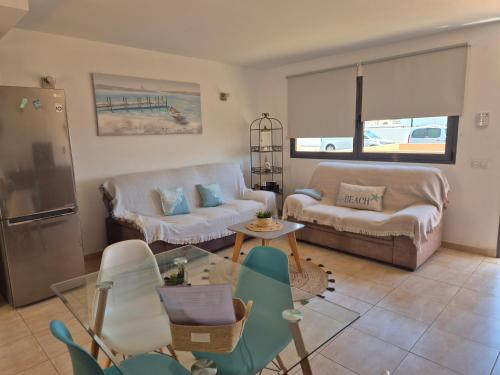 a living room with a couch and a table at Casa en Cotillo Lagos with Wifi & Netflix in Cotillo