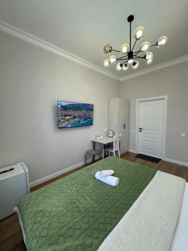 a bedroom with a large bed with a green rug at Rose Art hotel in Astana