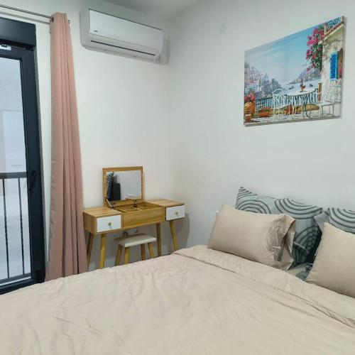 a bedroom with a bed and a desk with a mirror at Blue Bay Boutique Studio in Đenovići