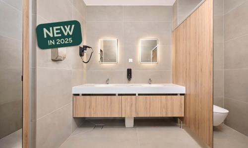 a bathroom with a sink and a sign on the wall at Aminess Style Camping Atea Resort - Pitches in Njivice