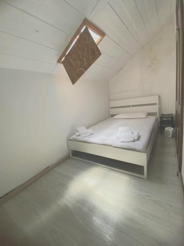 a small bedroom with a bed with a window at Private Room 203 in Guest House da Fonte in Figueira da Foz