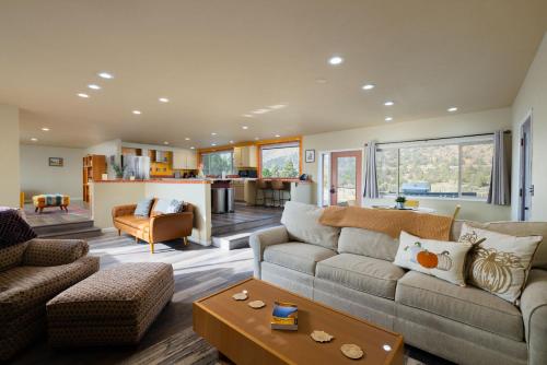 Una sala de estar con un sofá y una cocina. en Steps from Smith Rock in Prime Location, en Terrebonne