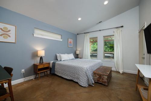 a blue bedroom with a bed and a window at Private Hot-Tub- 3 BDR for 8 Pet's OK in Bend