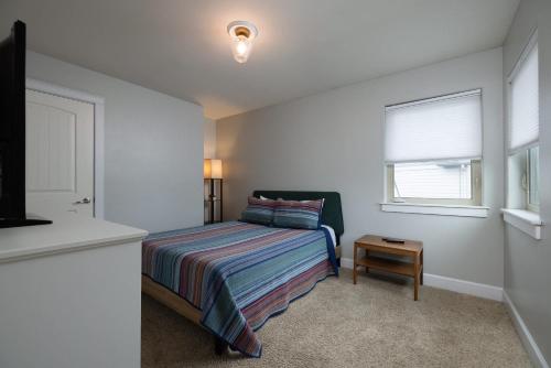 a small bedroom with a bed and a window at Private Hot-Tub- 3 BDR for 8 Pet's OK in Bend