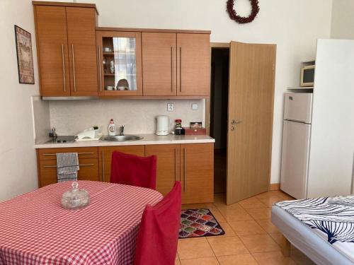 a kitchen with a table and a sink and a refrigerator at Aparthotel City 5 in Prague