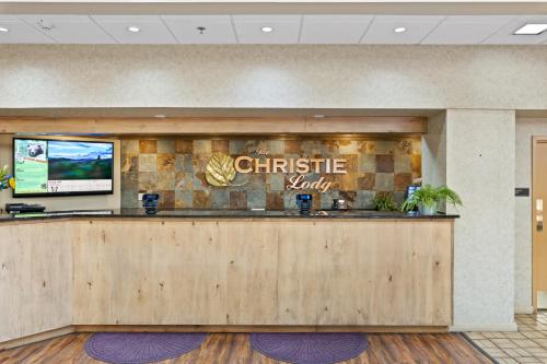 a christmas lobby with a christmas monkey sign on the wall at The Christie Lodge – All Suite Property Vail Valley/Beaver Creek in Avon