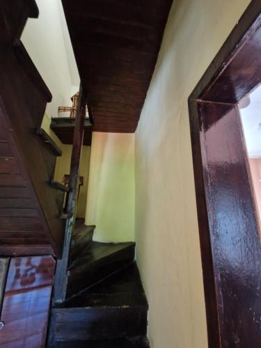 a stairway in a house with a wooden door at Къщи за гости "Зелената долина" in Dalbok-Dol