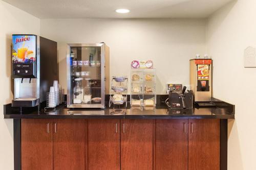 a kitchen with a counter with a coffee machine at Cobblestone Hotel & Suites - Knoxville in Knoxville