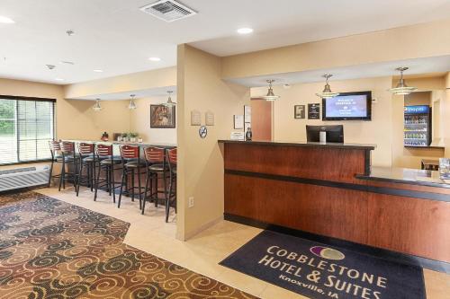 a hotel lobby with a bar and a restaurant at Cobblestone Hotel & Suites - Knoxville in Knoxville