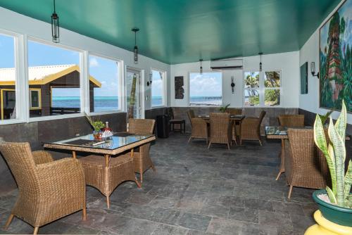 a dining room with tables and chairs and the ocean at X'tan Ha- The Waterfront in San Pedro