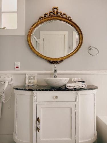 a bathroom with a sink and a mirror on the wall at La Belle Provence in Itaipava