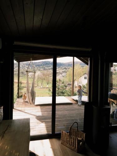 a room with a sliding glass door with a swing at Mahiya Vitriv in Staryy Sambor