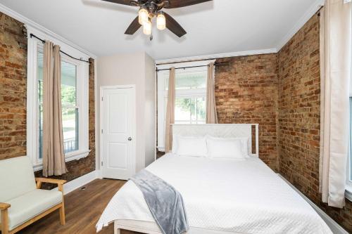 a bedroom with a bed and a brick wall at Ludlow Lodge with City Views in Ludlow