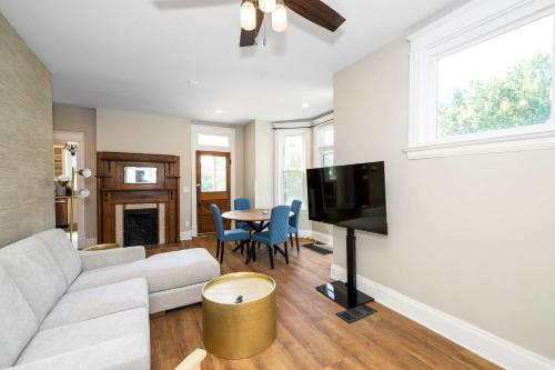 a living room with a couch and a tv at Ludlow Lodge with City Views in Ludlow