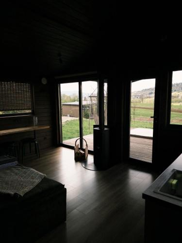 a bedroom with windows and a bed and a wooden floor at Mahiya Vitriv in Staryy Sambor