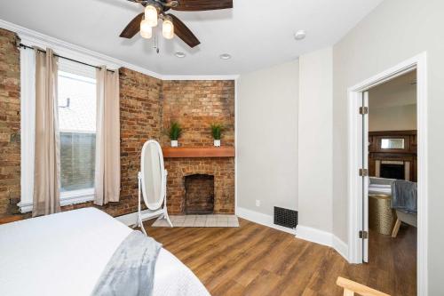 a bedroom with a brick fireplace and a bed at Ludlow Lodge with City Views in Ludlow