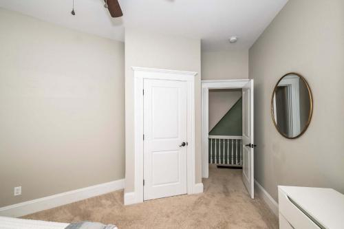 a bedroom with a white door and a mirror at Ludlow Lodge with City Views in Ludlow