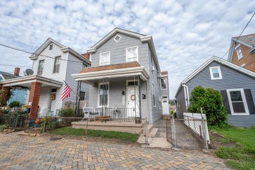 a white house with a flag on the front of it at Historic Ludlow Suites - 2 Apts in Ludlow