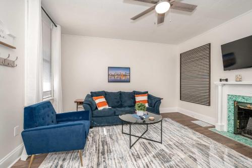 a living room with a blue couch and a fireplace at Historic Ludlow Suites - 2 Apts in Ludlow