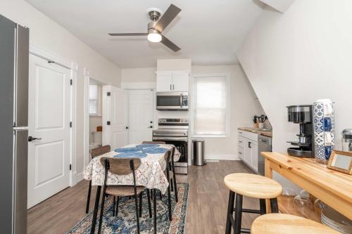 a kitchen with a table and some chairs in it at Historic Ludlow Suites - 2 Apts in Ludlow