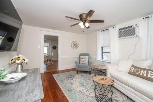 a living room with a couch and a ceiling fan at Historic Ludlow Suites - 2 Apts in Ludlow