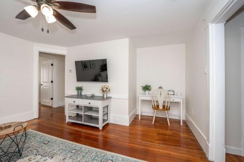 a living room with a ceiling fan and a white desk at Historic Ludlow Suites - 2 Apts in Ludlow
