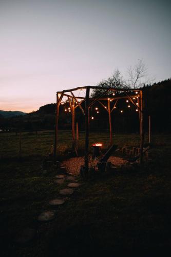 a gazebo with lights in a field at night at Mahiya Vitriv in Staryy Sambor