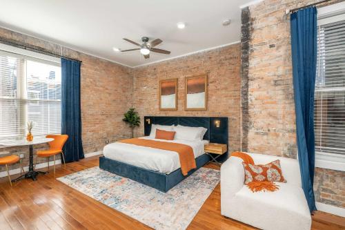 a bedroom with a brick wall and a bed at Findlay Market Suite 3 - For 2 in Cincinnati