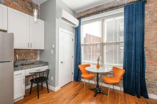a kitchen with a table and chairs and a window at Findlay Market Suite 3 - For 2 in Cincinnati