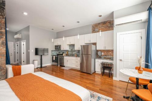 a bedroom with a bed and a kitchen at Findlay Market Suite 3 - For 2 in Cincinnati