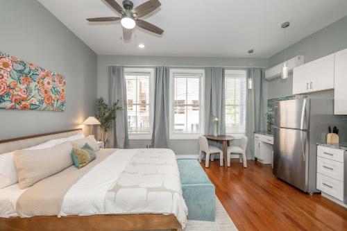 a bedroom with a bed and a table and a kitchen at Findlay Market Suite 2 - For 2 in Cincinnati