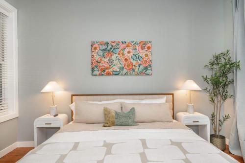 a bedroom with a large white bed with two lamps at Findlay Market Suite 2 - For 2 in Cincinnati