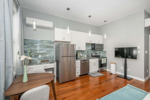 a kitchen with a stainless steel refrigerator and a table at Findlay Market Suite 2 - For 2 in Cincinnati