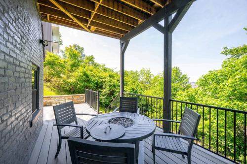 a patio with a table and chairs on a deck at Luxury Mt Adams Retreat Apt 1 in Cincinnati