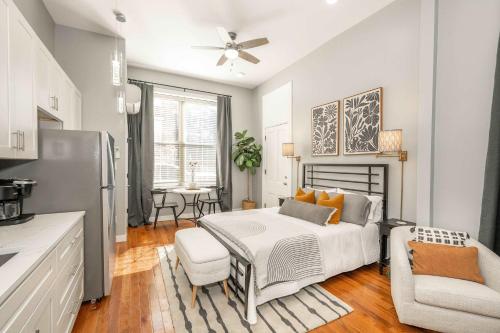 a bedroom with a bed and a table and a kitchen at Findlay Market Suite 1 - For 2 in Cincinnati