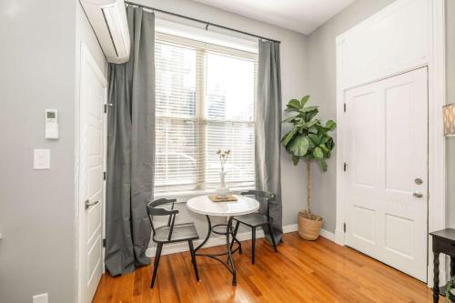 a table and chairs in a room with a window at Findlay Market Suite 1 - For 2 in Cincinnati