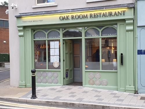 a green storefront of a restaurant on a street at Cois na hÉirne - Log Cabin I Lake View I Hot Tub in Belturbet