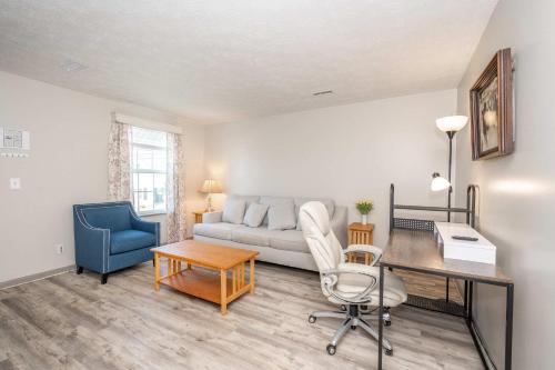 a living room with a couch and a desk at Arkstone Retreat 2 - Chic 2 Bedroom in Williamstown