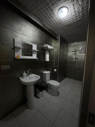 a bathroom with a toilet and a sink at De Perlas Otel in Atakum