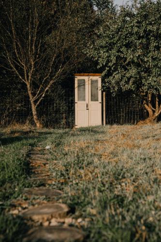 a white door in a field with a fence at Mahiya Vitriv in Staryy Sambor