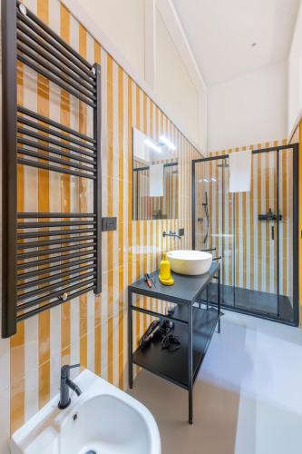 a bathroom with a sink and a toilet in it at Assoli House in Naples