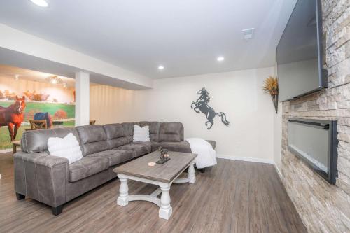 a living room with a couch and a tv at Horse Haven - 4 BDR Charmer Close to Ark Encounter in Williamstown